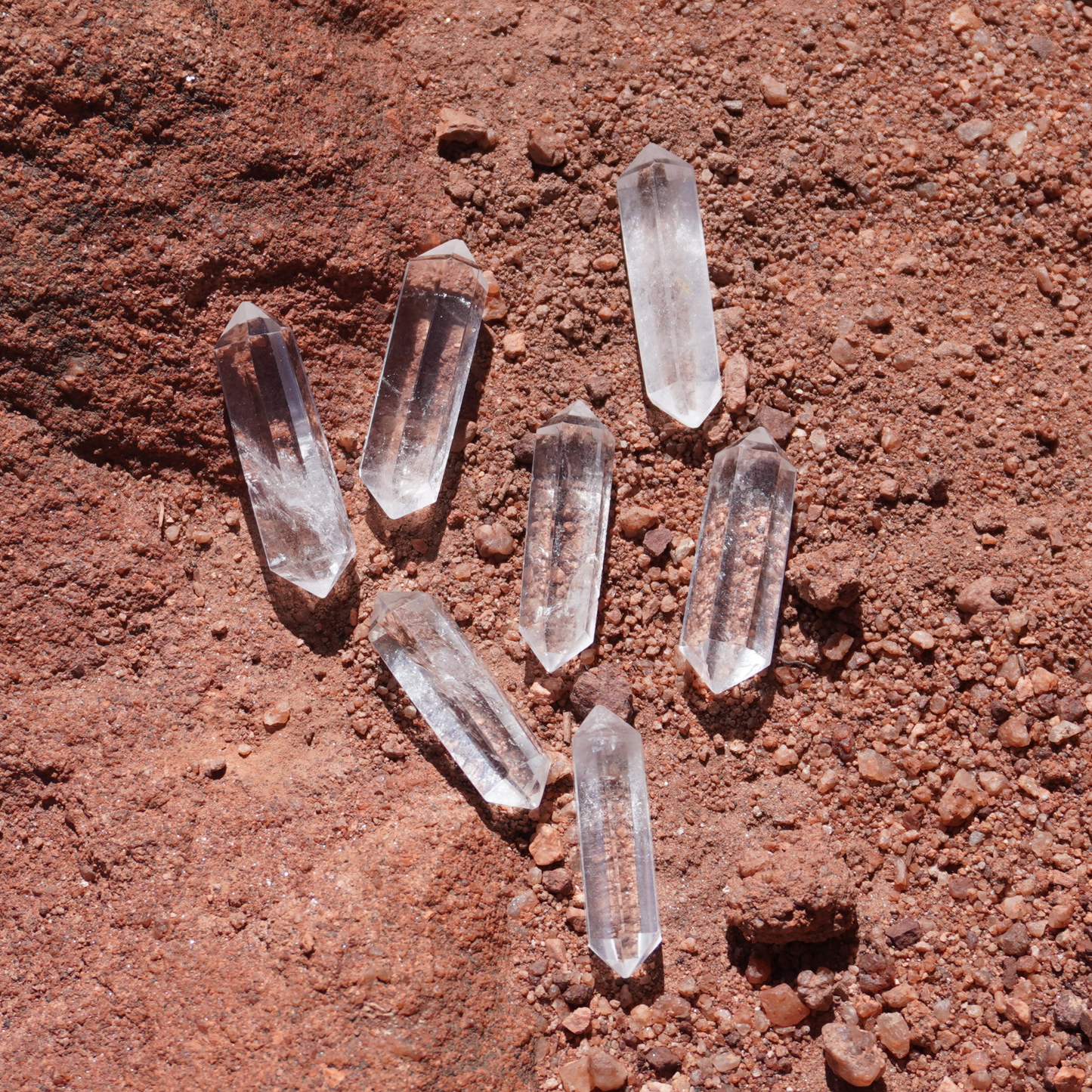 Hand showcasing a clear quartz point with natural inclusions, perfect for focused intention work