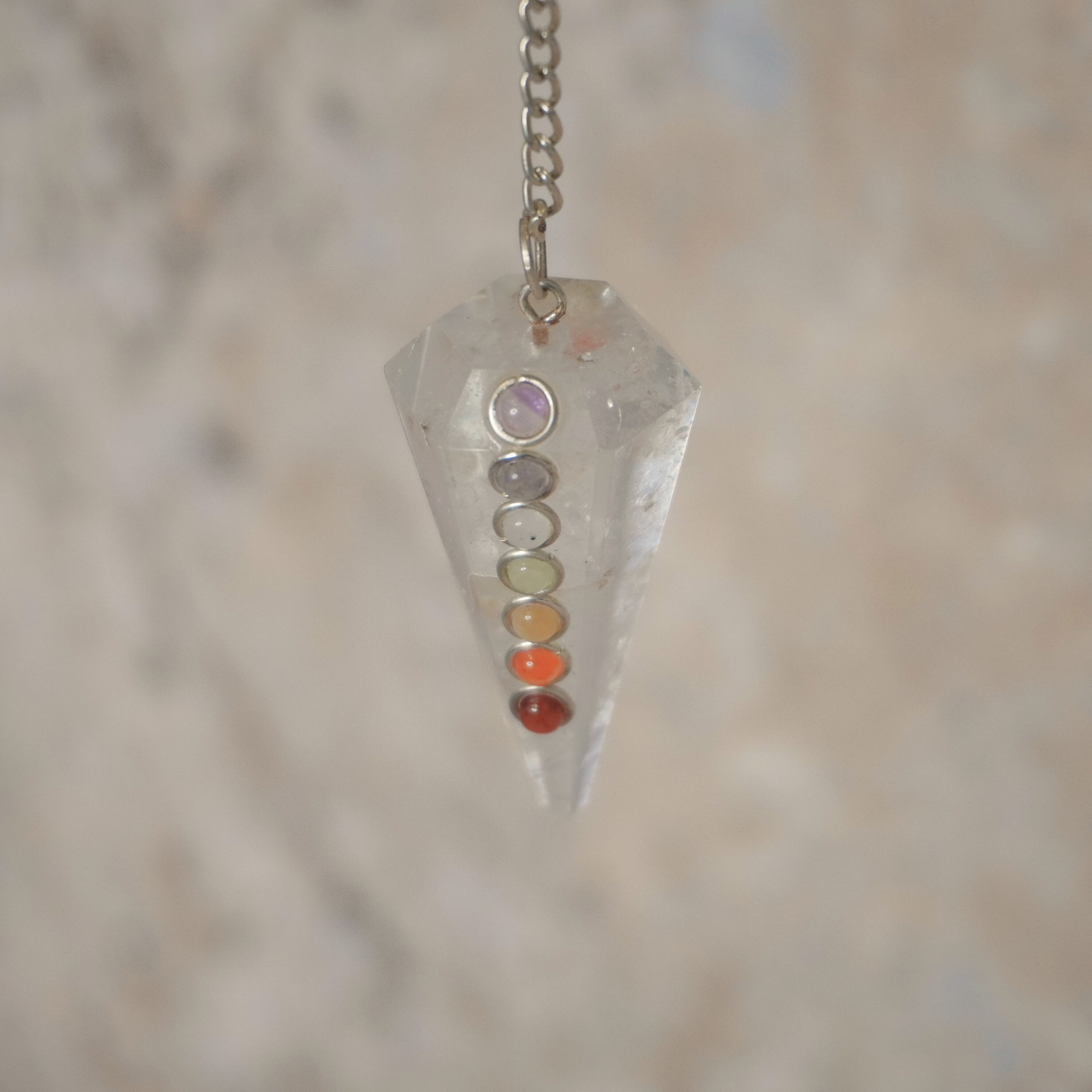 Crystal-clear quartz pendulum swinging for divination and energy amplification.