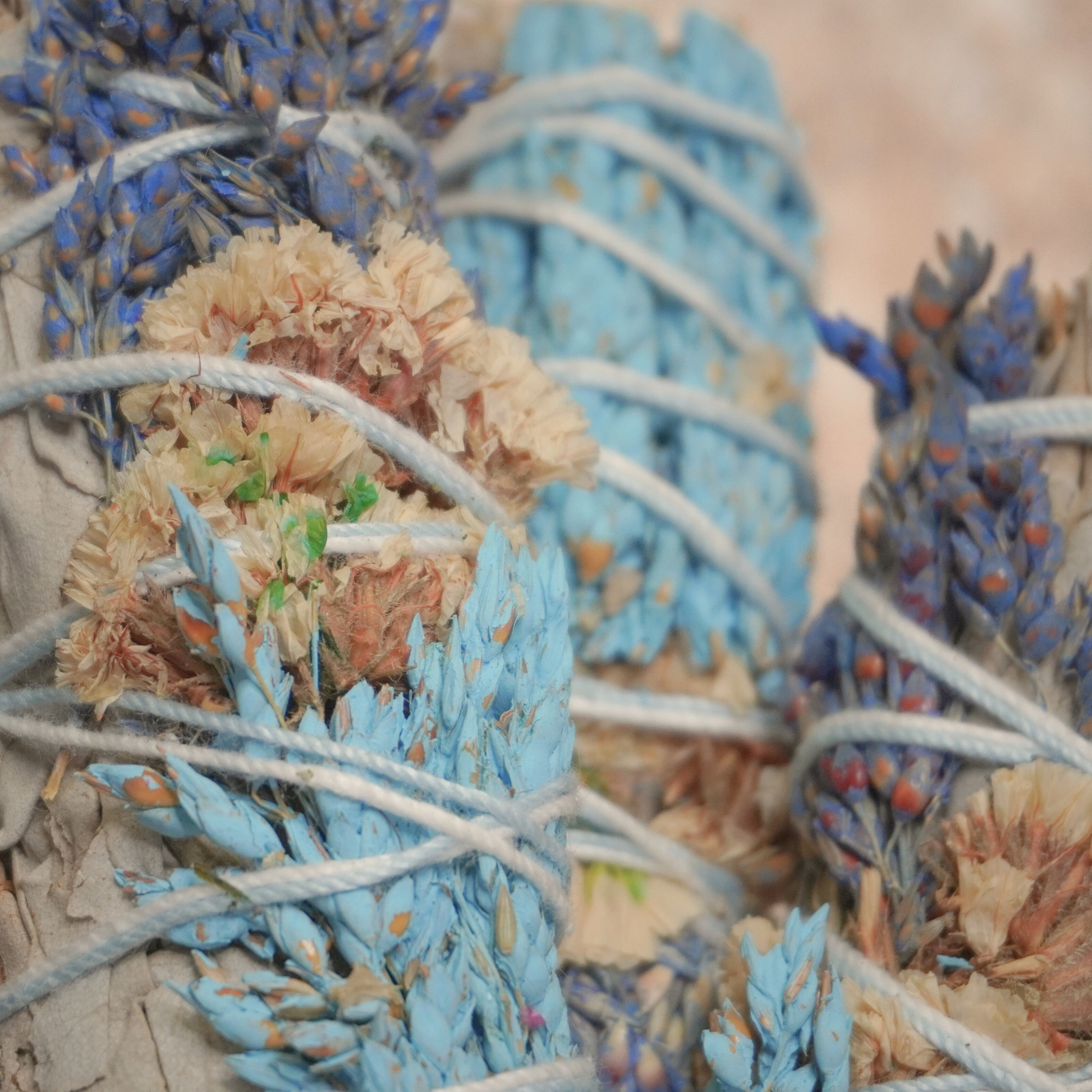 White sage bundles paired with sinuata flowers, ethically sourced from California, used for smudging and grounding practices.