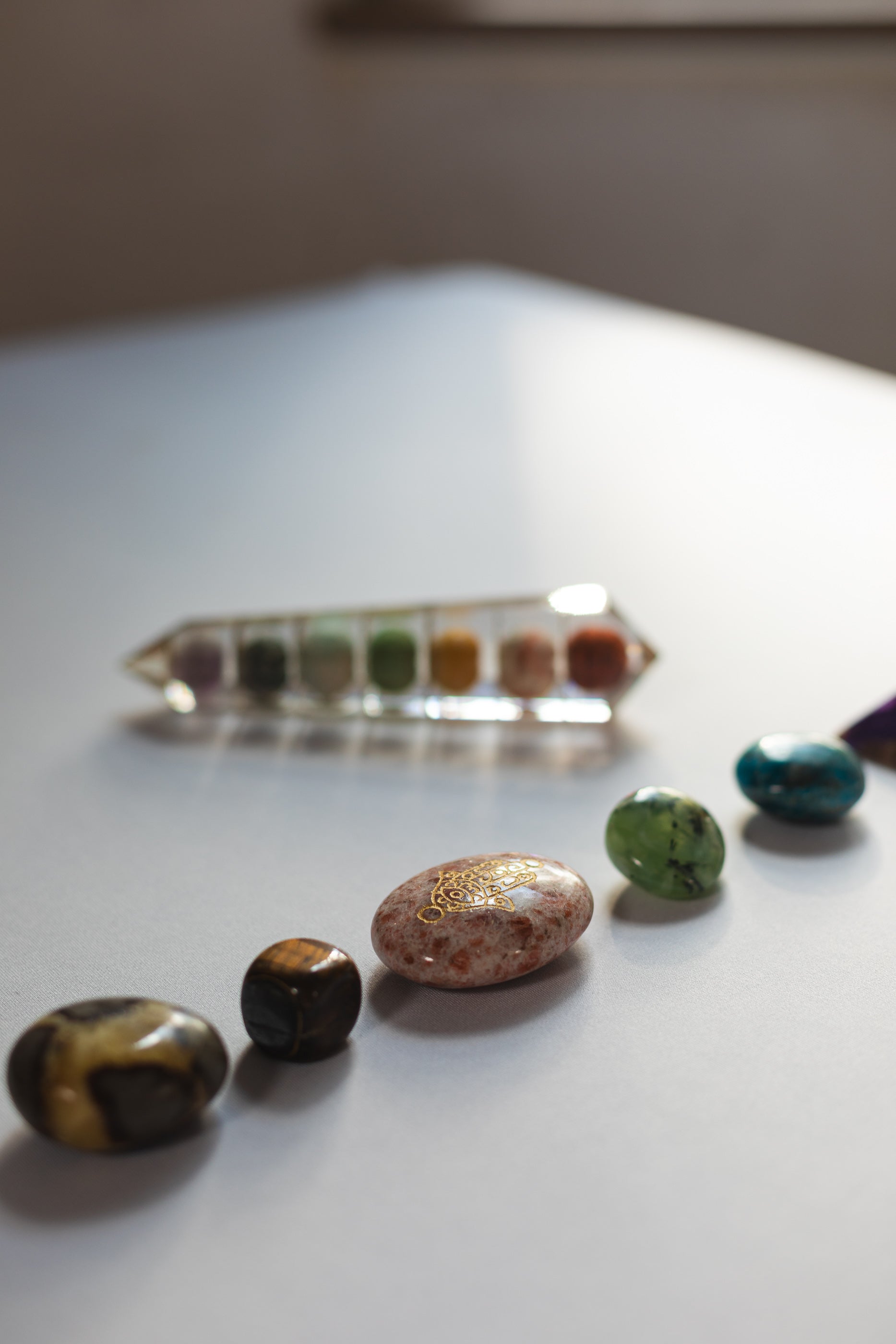 Selection of healing crystals used by Sacred Owl Healers during a Chakra Balancing session to align energy centers and restore balance.