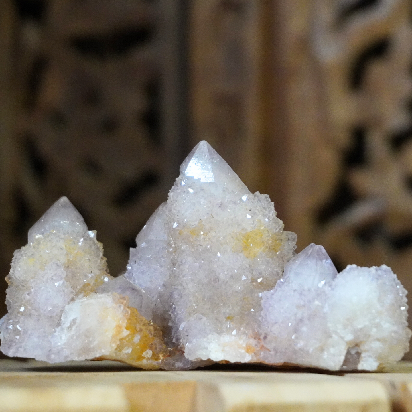 Spirit Cactus Quartz crystal on a dark wood background, emphasizing its high-quality craftsmanship